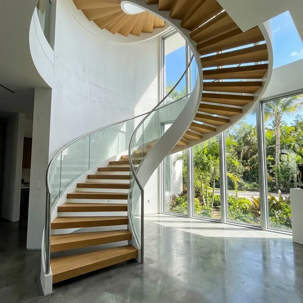 Completed curved cantilevered staircase with white oak treads in a Long Island home