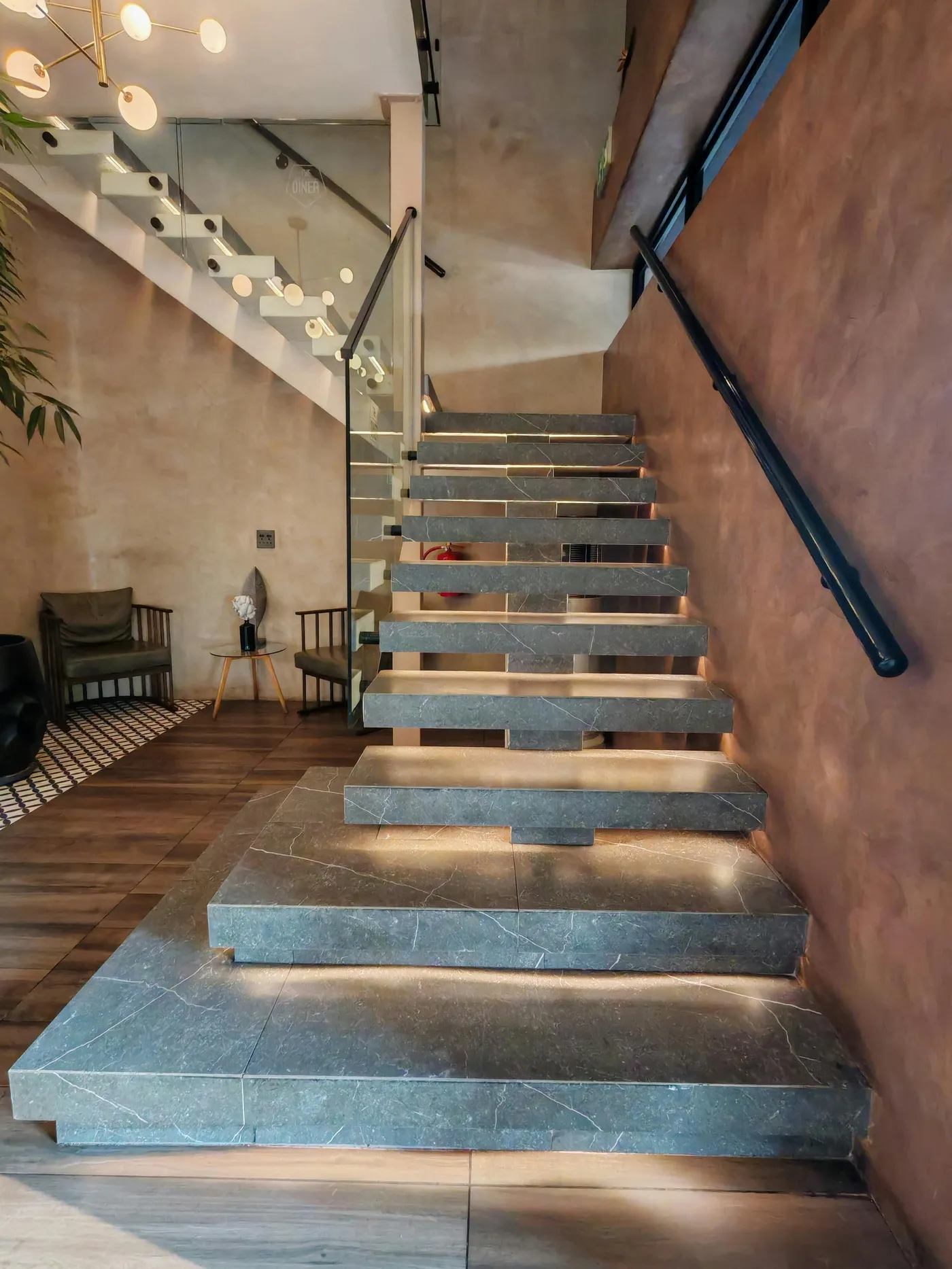 Integrated LED lighting system illuminating floating stair treads in a Nassau County home